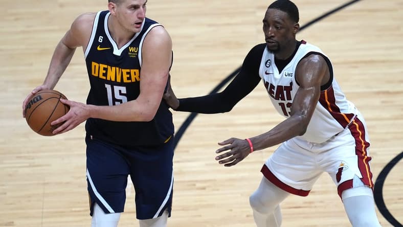 Jun 9, 2023; Miami, Florida, USA; Denver Nuggets center Nikola Jokic (15) controls the ball while defended by Miami Heat center Bam Adebayo (13) during the second half in game four of the 2023 NBA Finals at Kaseya Center. Mandatory Credit: Jim Rassol-USA TODAY Sports