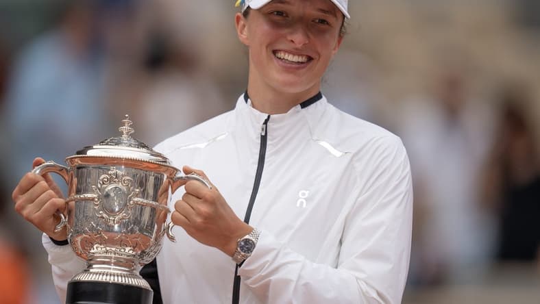 Jun 10, 2023; Paris,France; Iga Swiatek (POL) poses with the trophy after defeating Karolina Muchova (CZE) on day 14 at Stade Roland-Garros. Mandatory Credit: Susan Mullane-USA TODAY Sports