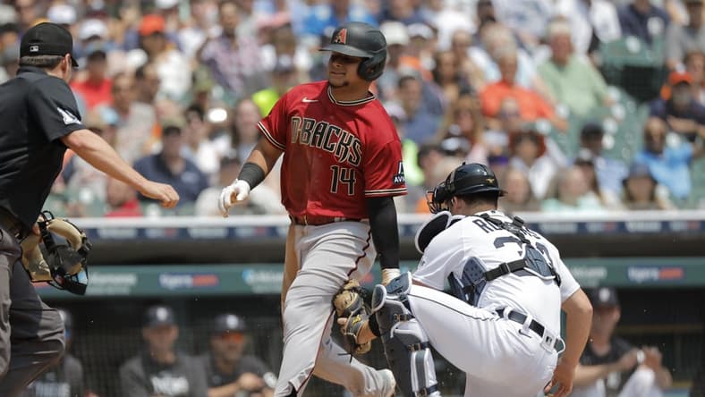 Jun 10, 2023; Detroit, Michigan, USA; Arizona Diamondbacks catcher Gabriel Moreno (14) is tagged out by Detroit Tigers catcher Jake Rogers (34) in the second inning at Comerica Park. Mandatory Credit: Rick Osentoski-USA TODAY Sports