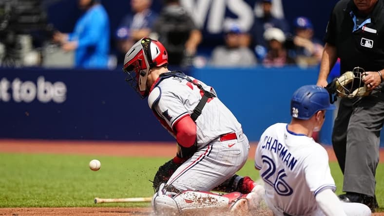 Jun 10, 2023; Toronto, Ontario, CAN; Minnesota Twins catcher Ryan Jeffers (27) takes the throw as Toronto Blue Jays third baseman Matt Chapman (26) scores on a single by Toronto second baseman Whit Merrifield (not pictured) during the second inning at Rogers Centre. Mandatory Credit: John E. Sokolowski-USA TODAY Sports