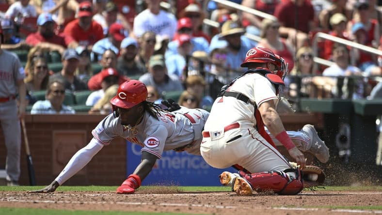 Jun 10, 2023; St. Louis, Missouri, USA; Cincinnati Reds third baseman Elly De La Cruz (44) slides safely into home ahead of the tag from St. Louis Cardinals catcher Andrew Knizner (7) in the seventh inning at Busch Stadium. Mandatory Credit: Joe Puetz-USA TODAY Sports