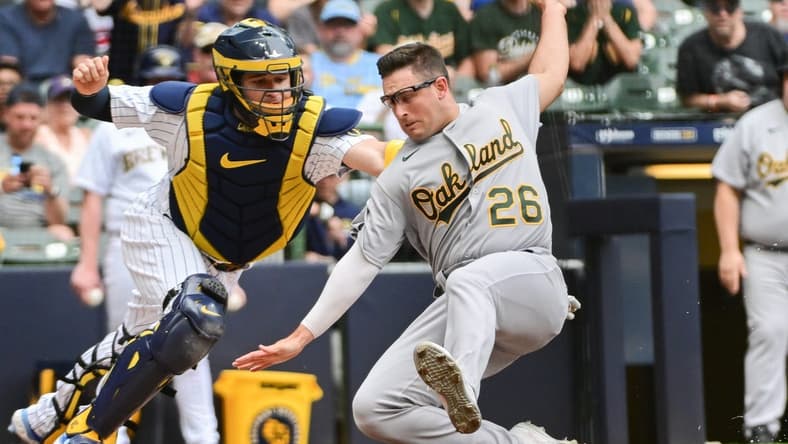 Jun 10, 2023; Milwaukee, Wisconsin, USA; Milwaukee Brewers catcher Victor Caratini (7) tags out Oakland Athletes third baseman Jonah Bride (26) in the second inning at American Family Field. Mandatory Credit: Benny Sieu-USA TODAY Sports