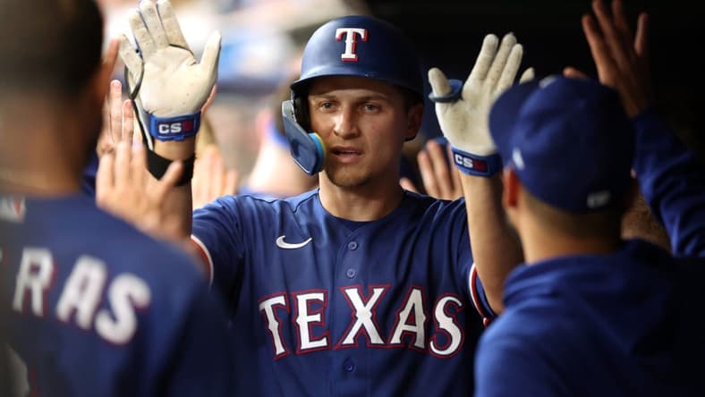 Jun 10, 2023; St. Petersburg, Florida, USA; Texas Rangers shortstop Corey Seager (5) is congratulated in the dugout after hitting a 2-run home run against the Tampa Bay Rays during the fourth inning at Tropicana Field. Mandatory Credit: Kim Klement-USA TODAY Sports