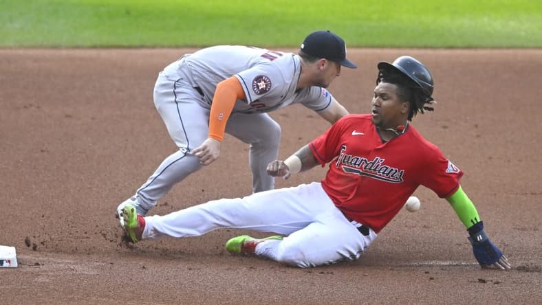 Jun 10, 2023; Cleveland, Ohio, USA; Cleveland Guardians third baseman Jose Ramirez (11) slides safely to third base beside Houston Astros third baseman Alex Bregman (2) in the first inning at Progressive Field. Mandatory Credit: David Richard-USA TODAY Sports