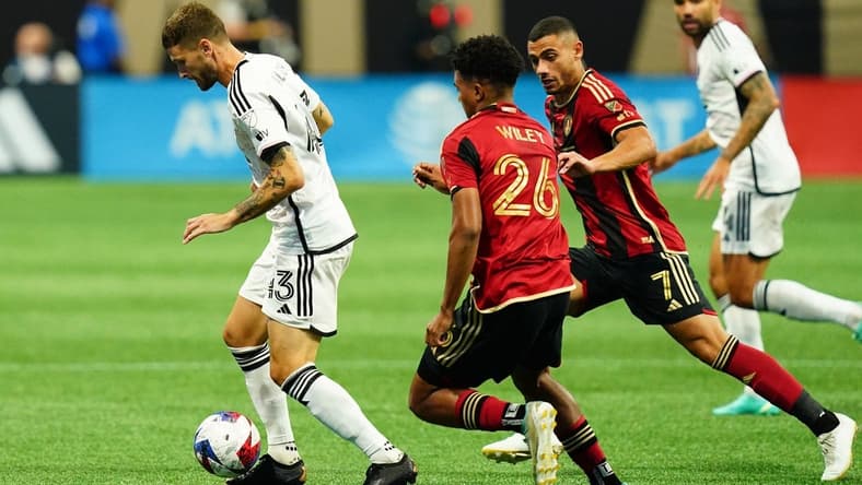 Jun 10, 2023; Atlanta, Georgia, USA; D.C. United midfielder Mateusz Klich (43) controls the ball against Atlanta United players during the first half at Mercedes-Benz Stadium. Mandatory Credit: John David Mercer-USA TODAY Sports