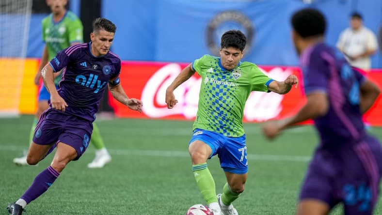 Jun 10, 2023; Charlotte, North Carolina, USA; Seattle Sounders forward Jordan Morris (13) tries to dribble past Charlotte FC midfielder Ashley Westwood (8) during the first half at Bank of America Stadium. Mandatory Credit: Jim Dedmon-USA TODAY Sports