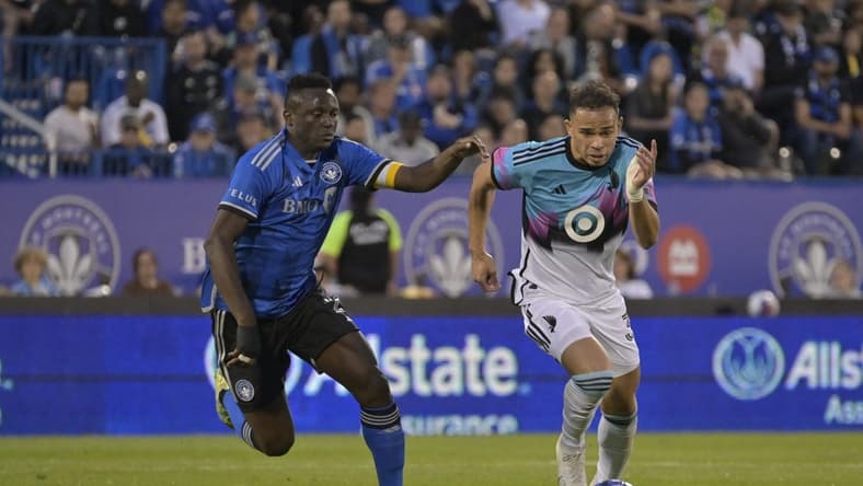 Jun 10, 2023; Montreal, Quebec, CAN; Minnesota United midfielder Hassani Dotson (31) plays the ball defended by CF Montreal midfielder Victor Wanyama (2) in the second half at Stade Saputo. Mandatory Credit: Eric Bolte-USA TODAY Sports