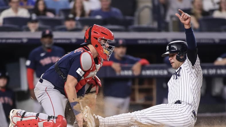 Jun 10, 2023; Bronx, New York, USA; Boston Red Sox catcher Reese McGuire (3) is unable to hold onto the ball allowing New York Yankees center fielder Isiah Kiner-Falefa (12) to score at Yankee Stadium. Mandatory Credit: Wendell Cruz-USA TODAY Sports