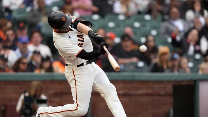 Jun 10, 2023; San Francisco, California, USA; San Francisco Giants left fielder Mitch Haniger (17) hits a double against the Chicago Cubs during the eighth inning at Oracle Park. Mandatory Credit: Darren Yamashita-USA TODAY Sports