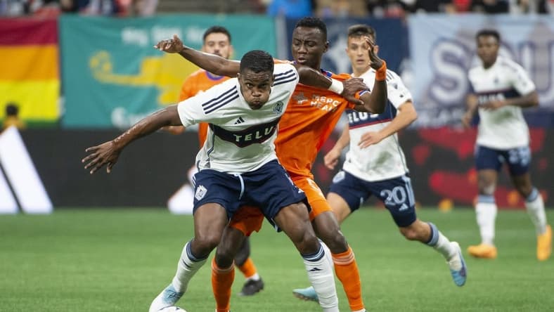 Jun 10, 2023; Vancouver, British Columbia, CAN;  Vancouver Whitecaps FC forward Sergio Cordova (9) and FC Cincinnati midfielder Obinna Nwobodo (5) battle for the ball during the first half at BC Place. Mandatory Credit: Anne-Marie Sorvin-USA TODAY Sports