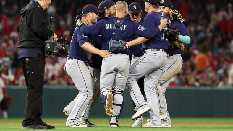 Jun 10, 2023; Anaheim, California, USA; Seattle Mariners infielders celebrate a victory against the Los Angeles Angels after defeating the Angels 6-2 at Angel Stadium. Mandatory Credit: Kiyoshi Mio-USA TODAY Sports