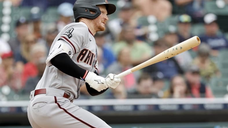 Jun 11, 2023; Detroit, Michigan, USA; Arizona Diamondbacks designated hitter Pavin Smith (26) hits a single in the seventh inning against the Detroit Tigers at Comerica Park. Mandatory Credit: Rick Osentoski-USA TODAY Sports