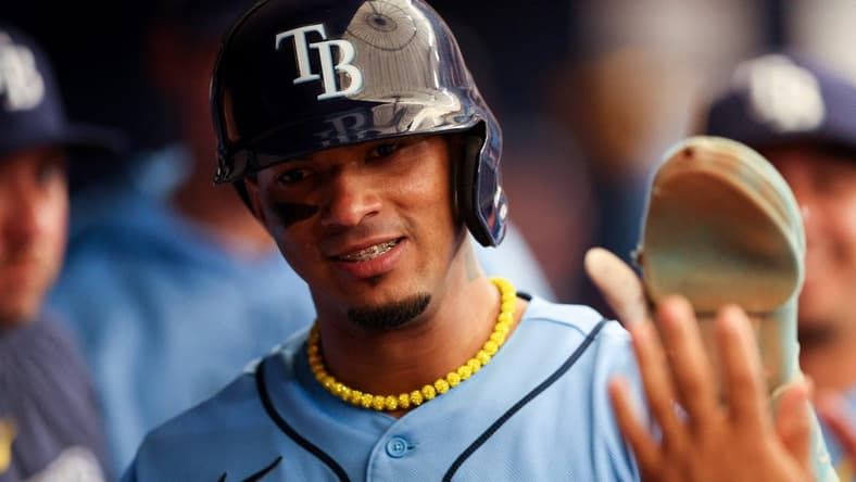 Jun 11, 2023; St. Petersburg, Florida, USA; Tampa Bay Rays shortstop Wander Franco (5) celebrates in the dugout after scoring a run against the Texas Rangers in the first inning at Tropicana Field. Mandatory Credit: Nathan Ray Seebeck-USA TODAY Sports