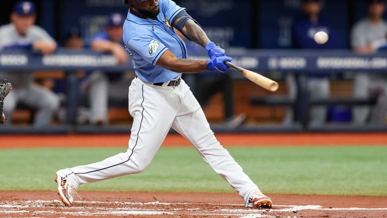 Jun 11, 2023; St. Petersburg, Florida, USA; Tampa Bay Rays left fielder Randy Arozarena (56) hits an rbi single against the Texas Rangers in the first inning at Tropicana Field. Mandatory Credit: Nathan Ray Seebeck-USA TODAY Sports