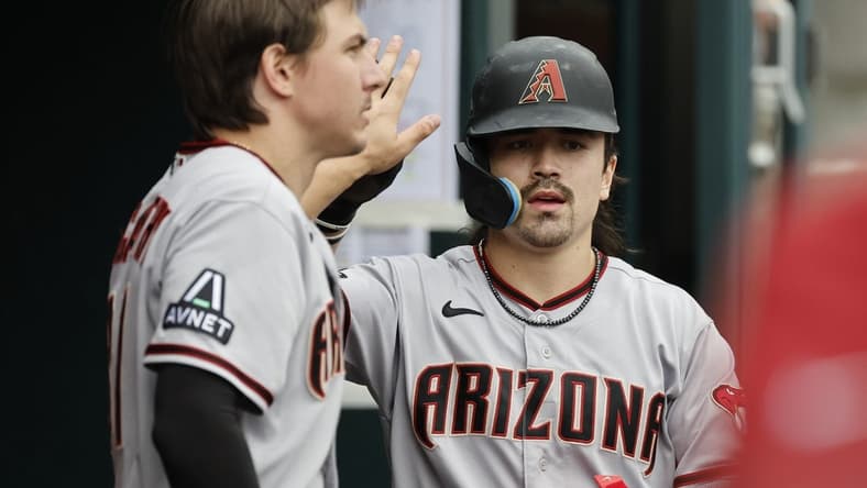 Jun 11, 2023; Detroit, Michigan, USA; Arizona Diamondbacks left fielder Corbin Carroll (7) receives congratulations from teammates after scoring against the Detroit Tigers at Comerica Park. Mandatory Credit: Rick Osentoski-USA TODAY Sports