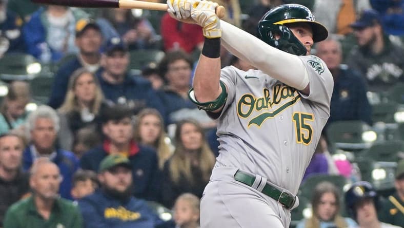 Jun 11, 2023; Milwaukee, Wisconsin, USA; Oakland Athletes left fielder Seth Brown (15) hits a 3-run home run against the Milwaukee Brewers in the fourth inning at American Family Field. Mandatory Credit: Benny Sieu-USA TODAY Sports