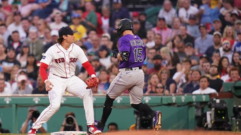 Jun 12, 2023; Boston, Massachusetts, USA; Colorado Rockies right fielder Randal Grichuk (15) gets a base hit and the Rockies score on a a poor throw to Boston Red Sox first baseman Triston Casas (36) in the fourth inning at Fenway Park. Mandatory Credit: David Butler II-USA TODAY Sports