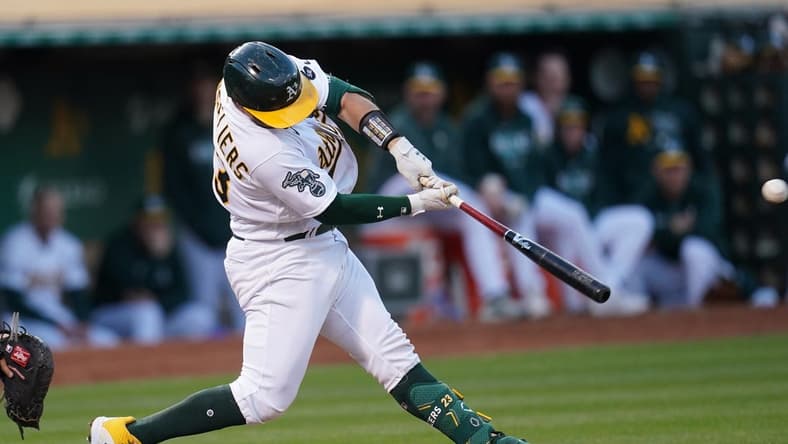 Jun 12, 2023; Oakland, California, USA; Oakland Athletics catcher Shea Langeliers (23) hits a three-run double against the Tampa Bay Rays in the fifth inning at Oakland-Alameda County Coliseum. Mandatory Credit: Cary Edmondson-USA TODAY Sports