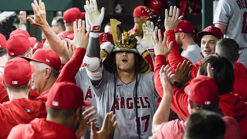 Jun 12, 2023; Arlington, Texas, USA; Los Angeles Angels starting pitcher Shohei Ohtani (17) is greeted in the dugout after hitting two run go ahead home run during the twelfth inning against the Texas Rangers at Globe Life Field. Mandatory Credit: Raymond Carlin III-USA TODAY Sports