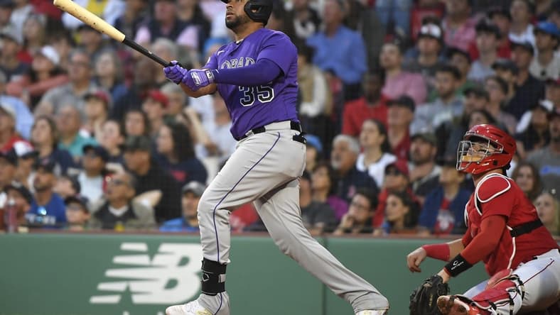 Jun 13, 2023; Boston, Massachusetts, USA; Colorado Rockies catcher Elias Diaz (35) hits an RBI double during the third inning against the Boston Red Sox at Fenway Park. Mandatory Credit: Bob DeChiara-USA TODAY Sports