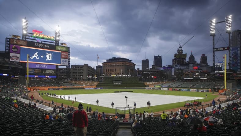 Jun 13, 2023; Detroit, Michigan, USA; The Detroit Tigers grounds crew works to put the tarp on the field during a rain delay at Comerica Park. Mandatory Credit: Brian Bradshaw Sevald-USA TODAY Sports
