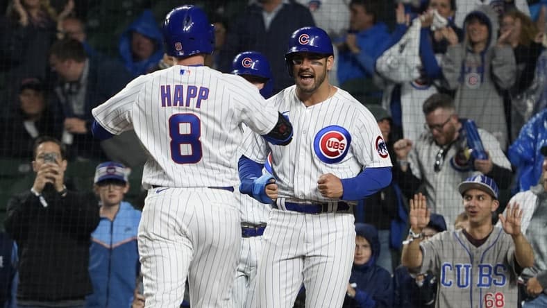 Jun 13, 2023; Chicago, Illinois, USA; Chicago Cubs left fielder Ian Happ (8) is greeted by center fielder Mike Tauchman (40) after hitting a three run homer against the Pittsburgh Pirates during the first inning at Wrigley Field. Mandatory Credit: David Banks-USA TODAY Sports