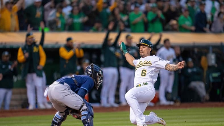 Jun 13, 2023; Oakland, California, USA; Oakland Athletics second baseman Jace Peterson (6) slides in safe against Tampa Bay Rays catcher Francisco Mejia (21) during the seventh inning at Oakland-Alameda County Coliseum. Mandatory Credit: Neville E. Guard-USA TODAY Sports