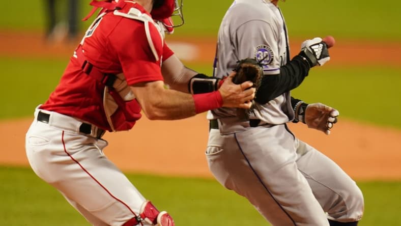 Jun 14, 2023; Boston, Massachusetts, USA; Colorado Rockies shortstop Ezequiel Tovar (14) tagged out at home plate by Boston Red Sox catcher Connor Wong (12) in the first inning at Fenway Park. Mandatory Credit: David Butler II-USA TODAY Sports