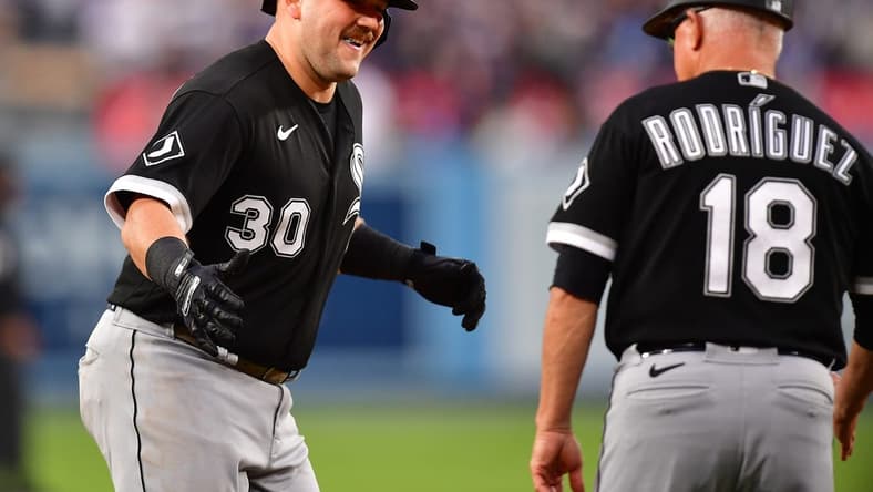 Jun 14, 2023; Los Angeles, California, USA; Chicago White Sox third baseman Jake Burger (30) is greeted by third base coach Eddie Rodriguez (18) after hitting a solo home run against the Los Angeles Dodgers during the second inning at Dodger Stadium. Mandatory Credit: Gary A. Vasquez-USA TODAY Sports
