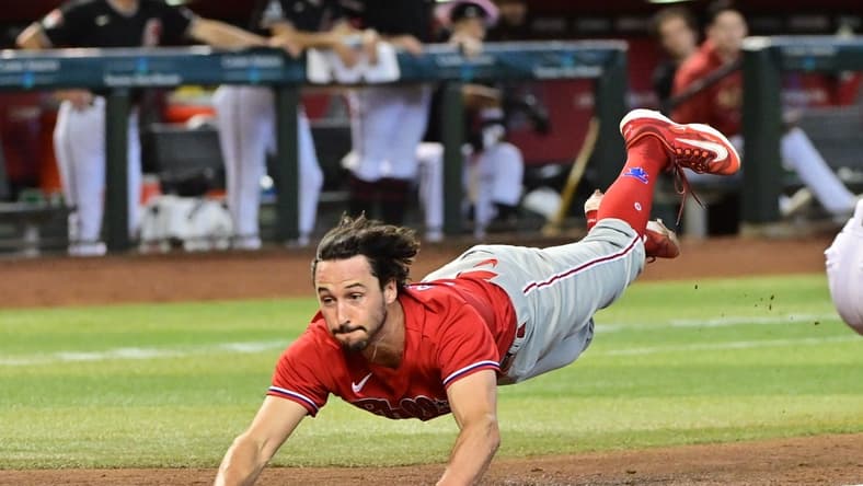 Jun 15, 2023; Phoenix, Arizona, USA;  Philadelphia Phillies catcher Garrett Stubbs (21) slides and scores in the fourth inning against the Arizona Diamondbacks at Chase Field. Mandatory Credit: Matt Kartozian-USA TODAY Sports