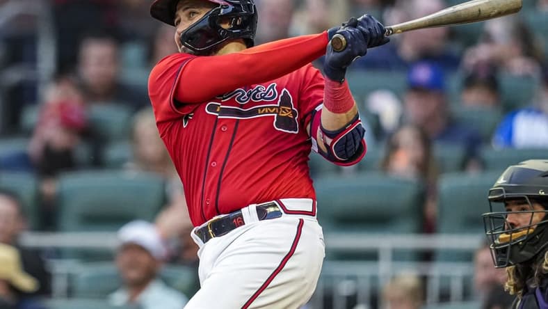 Jun 16, 2023; Cumberland, Georgia, USA; Atlanta Braves catcher Travis d'Arnaud (16) hits a home run against the Colorado Rockies during the third inning at Truist Park. Mandatory Credit: Dale Zanine-USA TODAY Sports