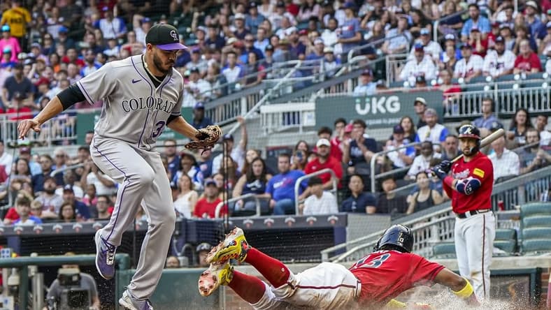 Jun 16, 2023; Cumberland, Georgia, USA; Atlanta Braves right fielder Ronald Acuna Jr. (13) scores under Colorado Rockies starting pitcher Dinelson Lamet (32) after a wild pitch during the first inning at Truist Park. Mandatory Credit: Dale Zanine-USA TODAY Sports