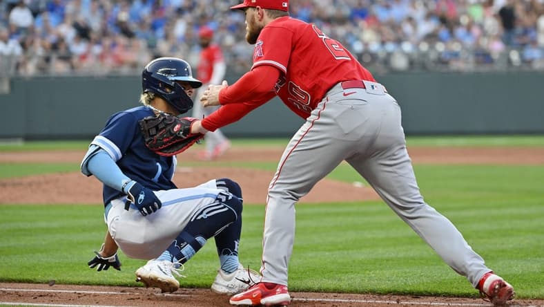 Jun 16, 2023; Kansas City, Missouri, USA; Los Angeles Angels first baseman Jared Walsh (20) tags out Kansas City Royals right fielder MJ Melendez (1) on the first baseline in the third inning at Kauffman Stadium. Mandatory Credit: Peter Aiken-USA TODAY Sports