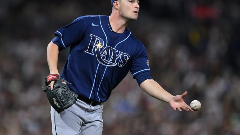 Jun 16, 2023; San Diego, California, USA; Tampa Bay Rays starting pitcher Shane McClanahan (18) tosses the ball to first base on a ground out by San Diego Padres left fielder Juan Soto (not pictured) during the sixth inning at Petco Park. Mandatory Credit: Orlando Ramirez-USA TODAY Sports