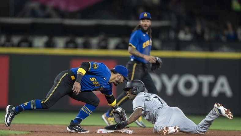 Jun 16, 2023; Seattle, Washington, USA; Chicago White Sox shortstop Tim Anderson (7) steals second against Seattle Mariners second baseman Jose Caballero during the third inning at T-Mobile Park. Mandatory Credit: Stephen Brashear-USA TODAY Sports