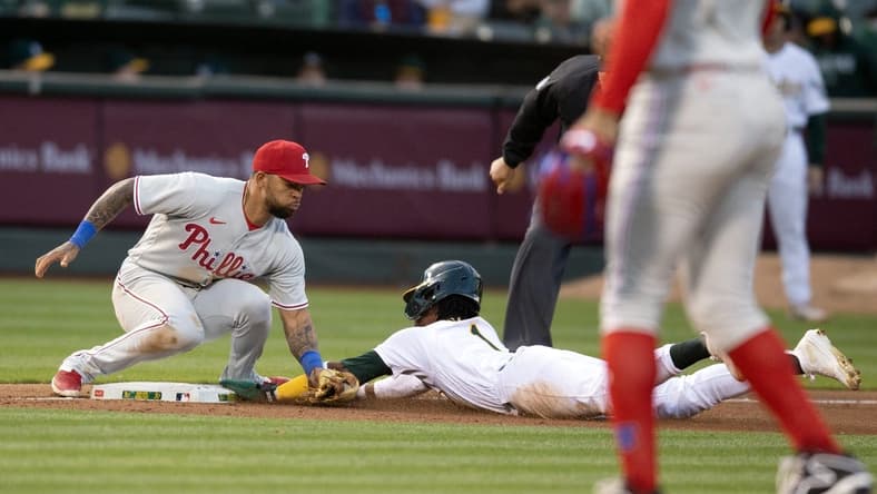 Jun 16, 2023; Oakland, California, USA; Oakland Athletics center fielder Esteury Ruiz (1) steals third base ahead of the tag by Philadelphia Phillies third baseman Edmundo Sosa (33) during the sixth inning at Oakland-Alameda County Coliseum. Mandatory Credit: D. Ross Cameron-USA TODAY Sports