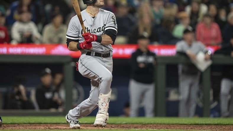 Jun 16, 2023; Seattle, Washington, USA; Chicago White Sox left fielder Andrew Benintendi (23) hits a solo home run off Seattle Mariners starting pitcher Bryan Woo (33) during the sixth inning at T-Mobile Park. Mandatory Credit: Stephen Brashear-USA TODAY Sports