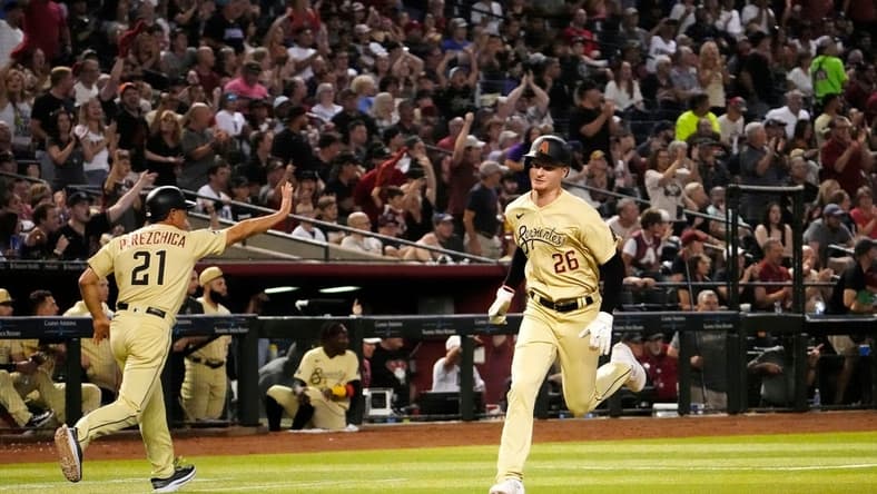 Jun 16, 2023; Phoenix, AZ, USA; Arizona Diamondbacks designated hitter Pavin Smith (26) scores on a Corbin Carroll RBI-double against the Cleveland Guardians in the sixth inning at Chase Field. Mandatory Credit: Rob Schumacher-Arizona Republic