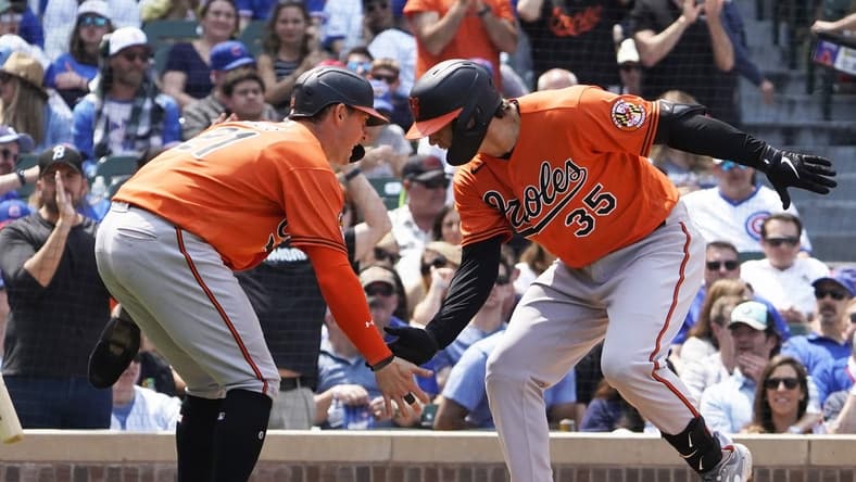 Jun 17, 2023; Chicago, Illinois, USA; Baltimore Orioles designated hitter Adley Rutschman (35) is greeted by left fielder Austin Hays (21) after hitting a home run against the Chicago Cubs during the fifth inning at Wrigley Field. Mandatory Credit: David Banks-USA TODAY Sports