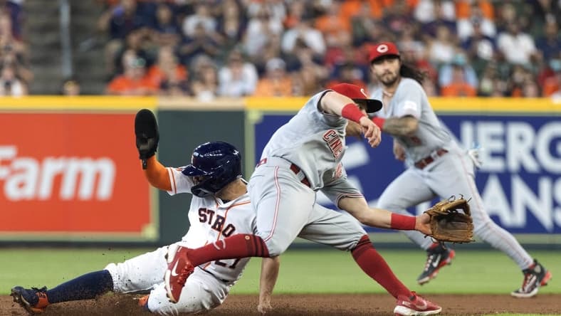 Jun 17, 2023; Houston, Texas, USA; Houston Astros second baseman Jose Altuve (27) steals second base against Cincinnati Reds shortstop Matt McLain (9) n the first inning at Minute Maid Park. Mandatory Credit: Thomas Shea-USA TODAY Sports