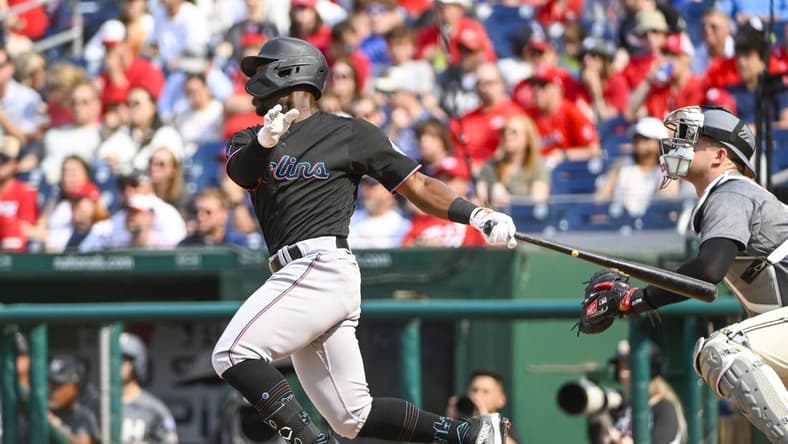 Jun 17, 2023; Washington, District of Columbia, USA; Miami Marlins center fielder Jonathan Davis (49) hits a RBI sacrifice fly against the Miami Marlins during the second inning at Nationals Park. Mandatory Credit: Brad Mills-USA TODAY Sports