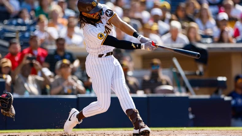 Jun 17, 2023; San Diego, California, USA;  San Diego Padres right fielder Fernando Tatis Jr. (23) hits a double in the first inning against the Tampa Bay Rays at Petco Park. Mandatory Credit: David Frerker-USA TODAY Sports