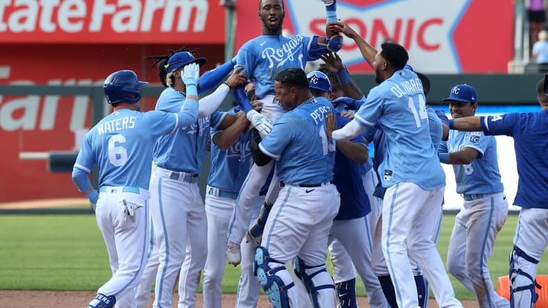 Jun 17, 2023; Kansas City, Missouri, USA; Kansas City Royals left fielder Samad Taylor (0) is lifted in the air by teammate Salvador Perez (13) after Taylor hit the game-winning single in his major league debut against the Los Angeles Angels at Kauffman Stadium. Mandatory Credit: Scott Sewell-USA TODAY Sports