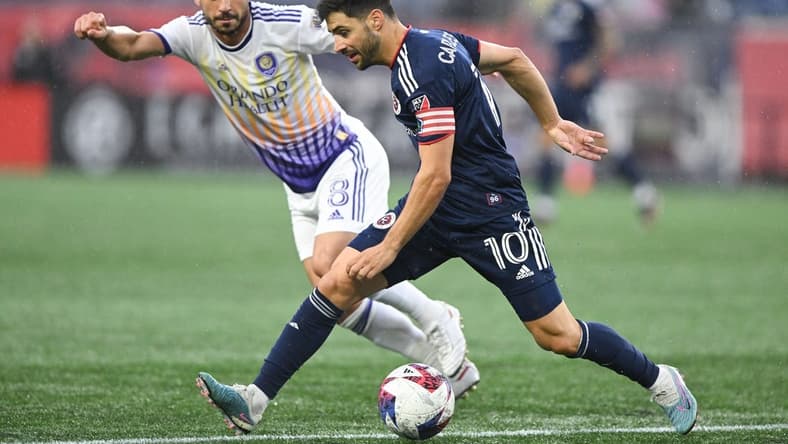 Jun 17, 2023; Foxborough, Massachusetts, USA; New England Revolution midfielder Carles Gil (10) controls the ball in front of Orlando City midfielder Felipe Martins (8) during the first half of a match at Gillette Stadium. Mandatory Credit: Brian Fluharty-USA TODAY Sports