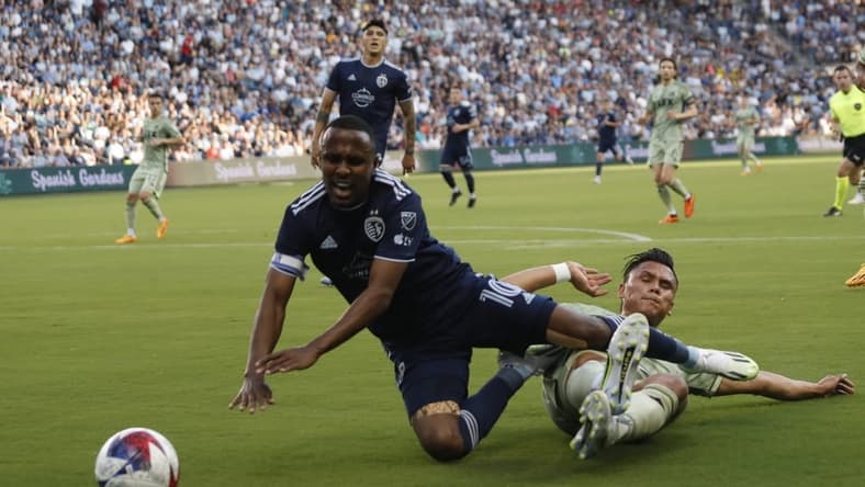 Jun 17, 2023; Kansas City, Kansas, USA; Sporting Kansas City midfielder Gadi Kinda (10) fights for the ball against Los Angeles FC During first half at Children's Mercy Park. Mandatory Credit: Kylie Graham-USA TODAY Sports