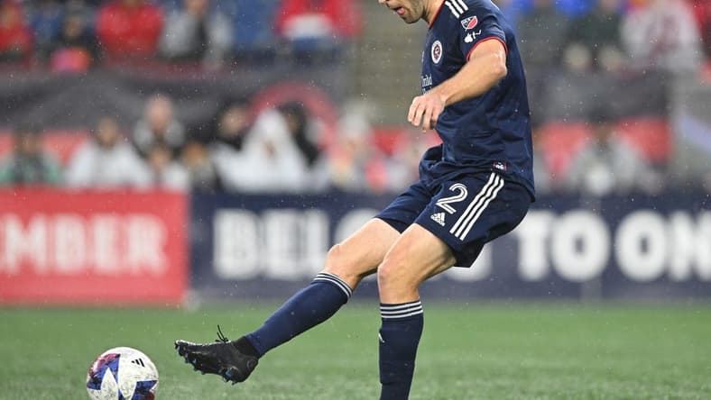 Jun 17, 2023; Foxborough, Massachusetts, USA; New England Revolution defender Dave Romney (2) kicks the ball during the first half of a match against Orlando City at Gillette Stadium. Mandatory Credit: Brian Fluharty-USA TODAY Sports