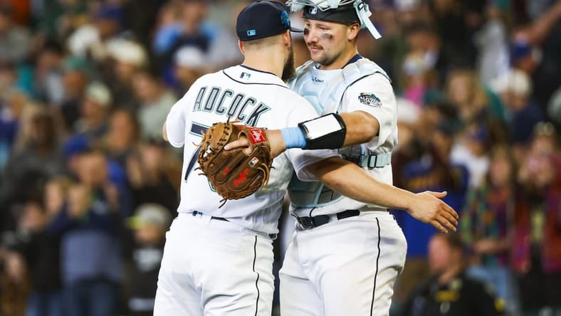Jun 18, 2023; Seattle, Washington, USA; Seattle Mariners relief pitcher Ty Adcock (70) hugs catcher Cal Raleigh (29) following a 5-1 victory against the Chicago White Sox at T-Mobile Park. Mandatory Credit: Joe Nicholson-USA TODAY Sports