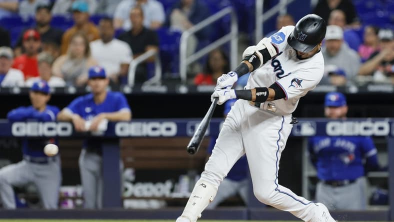 Jun 19, 2023; Miami, Florida, USA; Miami Marlins second baseman Luis Arraez (3) hits a single against the Toronto Blue Jays during the first inning at loanDepot Park. Mandatory Credit: Sam Navarro-USA TODAY Sports