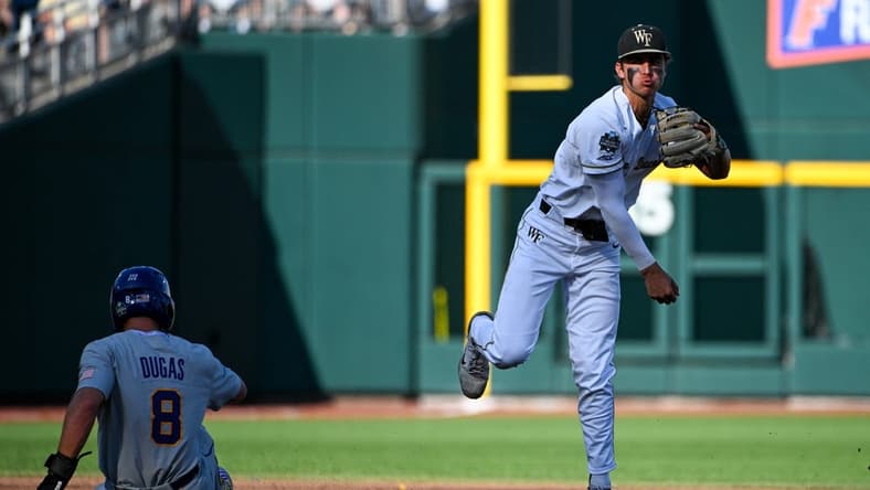 Jun 19, 2023; Omaha, NE, USA; Wake Forest Demon Deacons shortstop Marek Houston (7) completes a double play against Wake Forest Demon Deacons first baseman Nick Kurtz (8) in the second inning at Charles Schwab Field Omaha. Mandatory Credit: Steven Branscombe-USA TODAY Sports