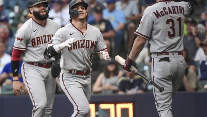 Jun 19, 2023; Milwaukee, Wisconsin, USA; Arizona Diamondbacks center fielder Alek Thomas (5) celebrates with third baseman Emmanuel Rivera (15) and right fielder Jake McCarthy (31) after hitting a two-run home run against the Milwaukee Brewers in the first inning at American Family Field. Mandatory Credit: Benny Sieu-USA TODAY Sports